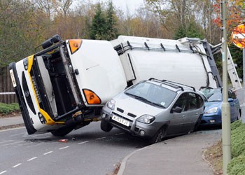 Three refuse collection workers were trapped inside the vehicle when it overturned in Whiteley, Fareham: (picture, The News, Portsmouth)